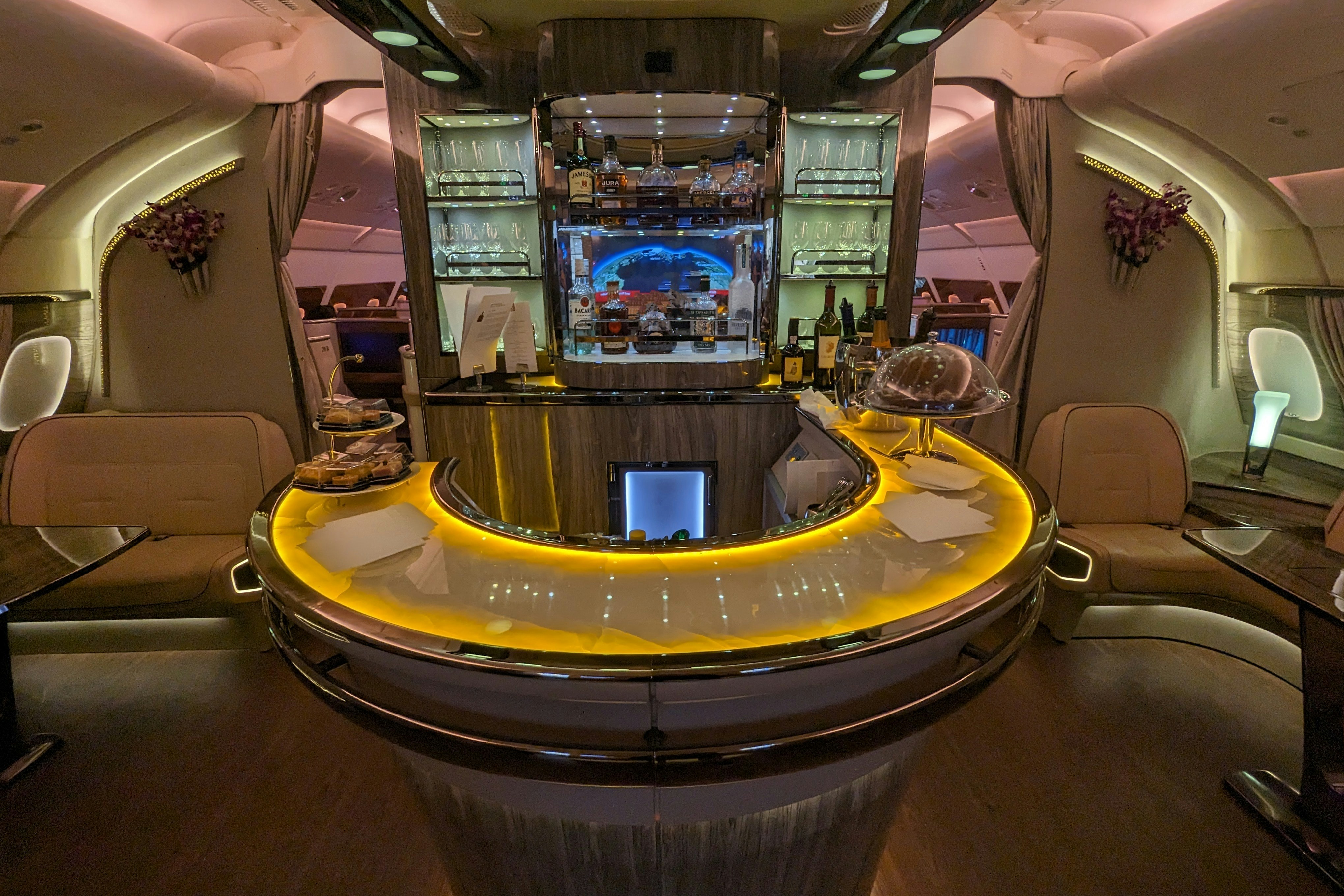 Business class cabin with warm amber lighting
